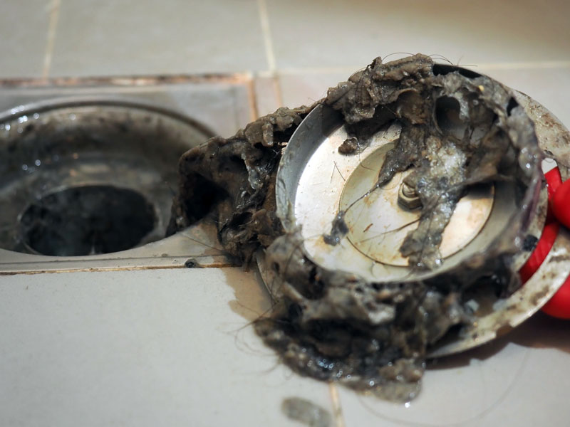 TAPS plumber clearing clogged drain in Houston bathroom shower