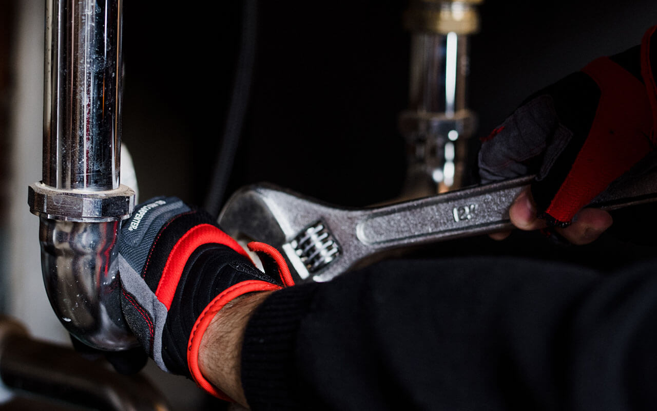 TAPS plumber repairing plumbing pipes inside Houston TX residential home