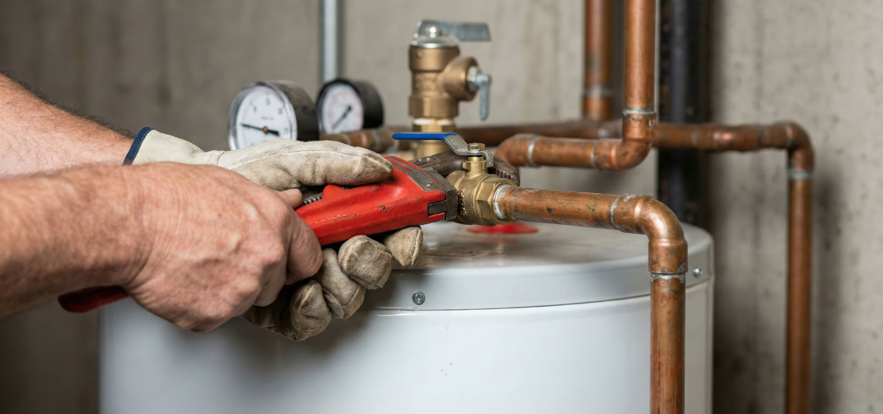 TAPS plumbing technician performing water heater repair in Houston home